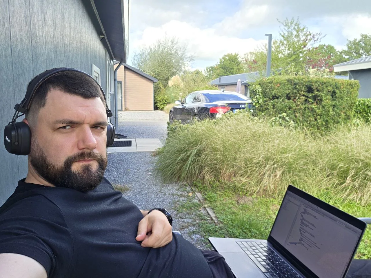 Sergiy working outdoors with his laptop in the Netherlands